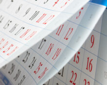 Flipping of sheets of calendar with black and red numbers