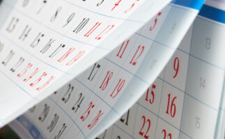 Flipping of sheets of calendar with black and red numbers