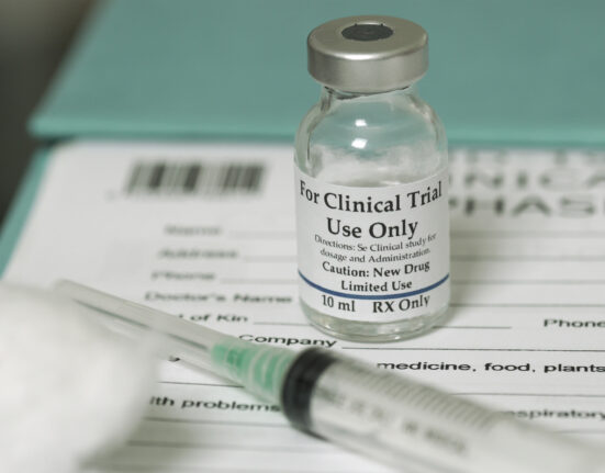 Clinical trial medicine, for the covid-19 coronavirus, on clipboard