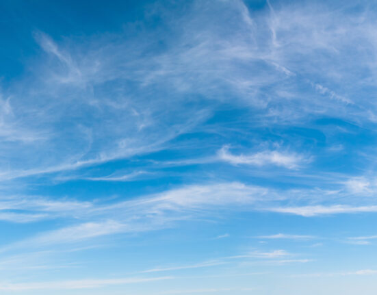 Beautiful Bright Blue sky with white clouds over the horizon in sunny windy day. Wide Angle Nature sky background, texture for Design. Natural Panoramic cloudy Wallpaper or Web banner With Copy Space