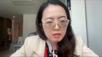 upclose shot of woman wearing glasses and a white coat