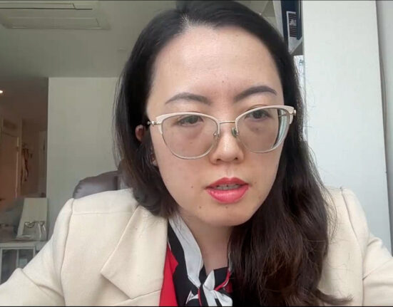 upclose shot of woman wearing glasses and a white coat